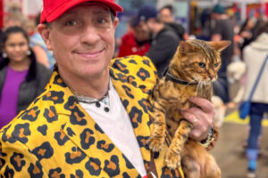 A bold attendee shares his views and Bengal cat in style.